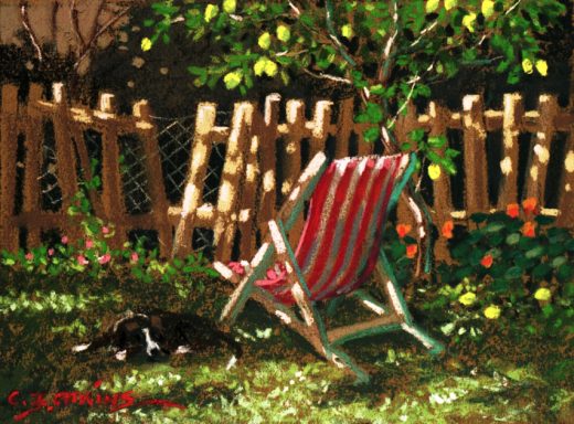 A deckchair and a dog are next to a lemon tree.