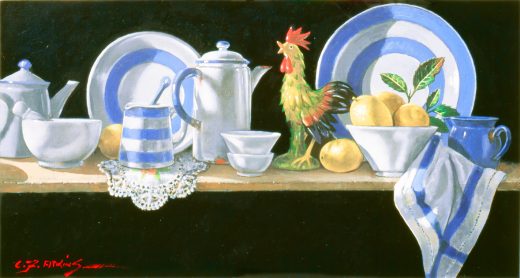 Blue and white china and cloths accompany a brightly-coloured ceramic rooster.