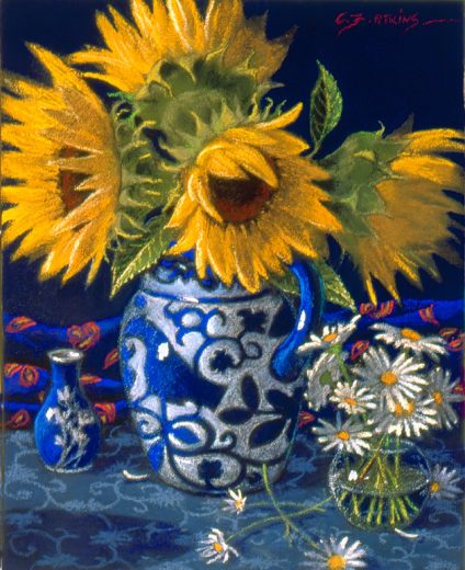 The sunflowers are in a blue and white jug with a bird motif.