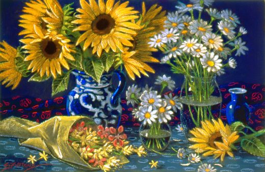 A bowl of daisies and a bunch of other flowers accompany the sunflowers.