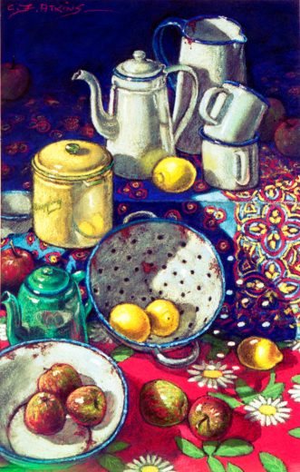 Enamelware and yellow lemons are on blue and red patterned cloths.