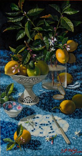 Lemons in a ceramic bowl accompany dark lemon leaves in a glass vase.