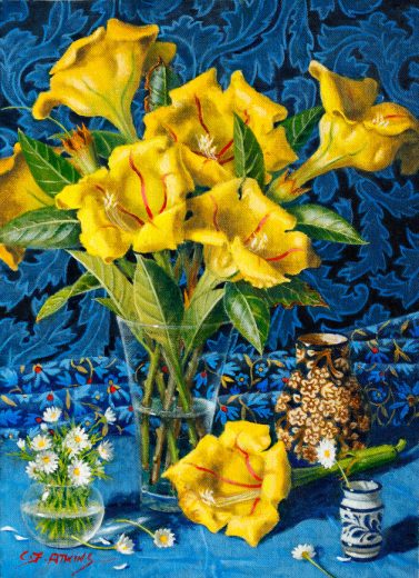 Several yellow flowers are in a vase in front of a blue background.