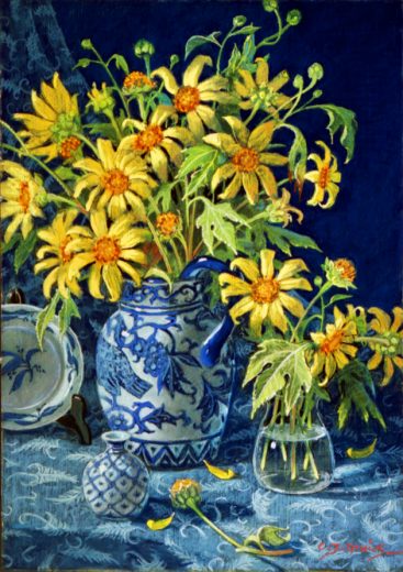 A blue and white jug holds yellow flowers.