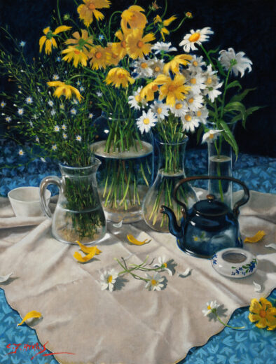 Four vases containing flowers and a blue teapot rest on a pale tablecloth.