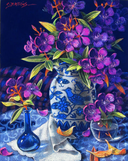 Purple tibouchina flowers in a jug with blue decoration.