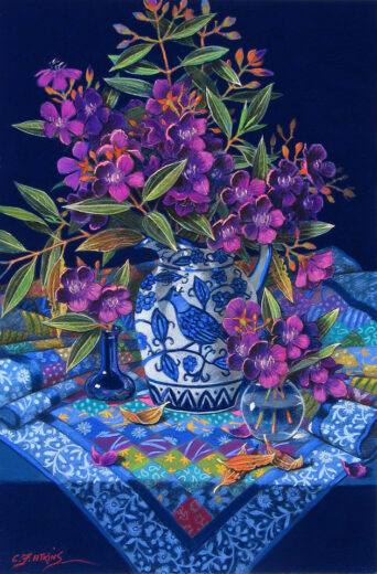 A jug of purple tibouchina flowers stands on a beautiful handmade cloth.
