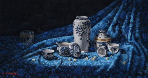 Ceramics on a blue patterned cloth.
