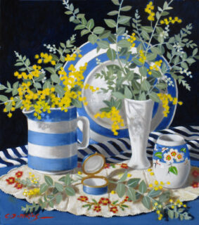 Wattle flowers are in a jug and a vase, a MakMerry motif is on one of the ceramics.
