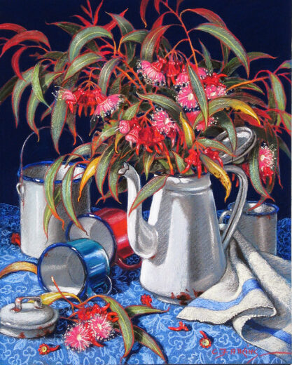 Coral gum leaves and flowers are in a white enamel coffee pot. Other coloured pieces of enamel are also in the picture.