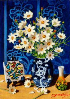 Yellow daisies in a blue vase with a blue background.