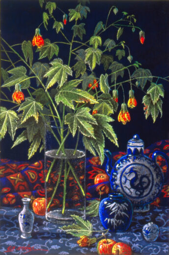 A teapot showing a blue dragon is accompanied by apples and a bowl of flowers.
