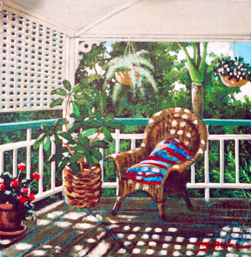 A sunny veranda looks out on a tropical garden outside.