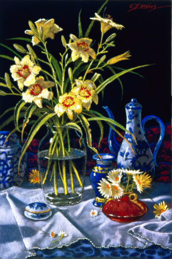 Yellow day lilies are accompanied by a slender blue and white coffee pot.