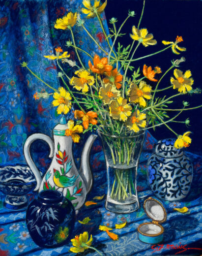 A glass vase of daisies is accompanied by a ceramic coffee pot. Behind these items is a richly decorated cloth.