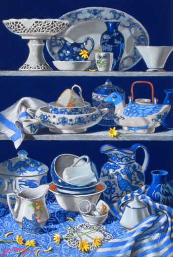 Blue and white pottery is arranged on shelves. One of the most prominent pieces is a ceramic teapot in the shape of a duck.
