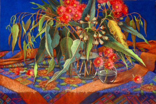 A vase of gum blossoms rests on a patterned cloth. The elongated leaves add interest to the painting.
