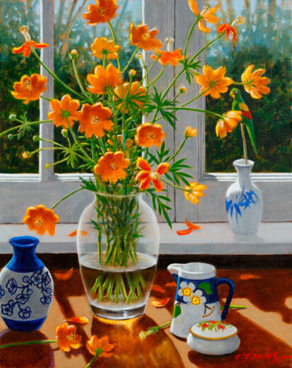 A vase of cosmos is just inside a closed window. A green bird on a stick nestles among the flowers.