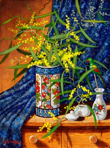 A vase of flowering wattle is on a shelf. A green sideshow bird on a stick leans towards the flowering wattle.