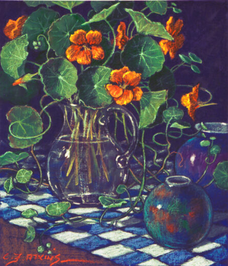 A bowl of Nasturtium flowers sit on a chequered cloth