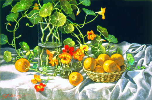 A vase of bright flowers is accompanied by oranges on a table.