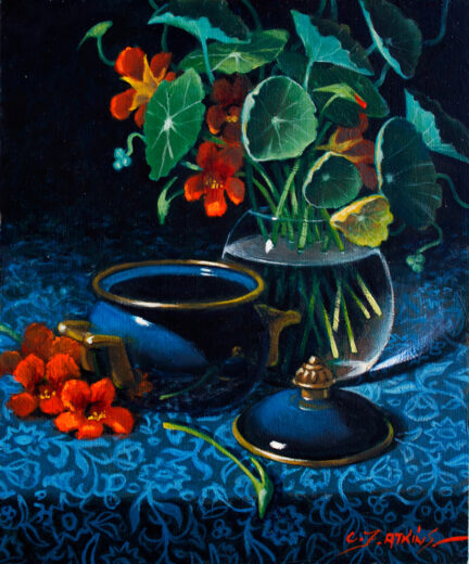 A bowl of nasturtium flowers sits next to a deep blue lidded pot.
