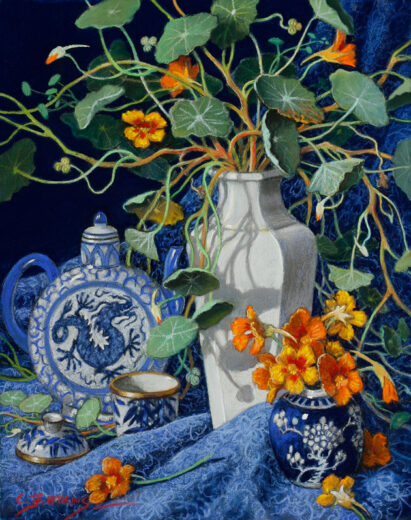 Nasturtium stems spill out of an elegant cream vase, A blue and white dragon teapot is nearby.