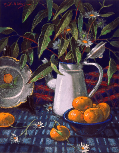 Orange fruit is in a dark blue bowl. Eucalypt leaves and daisies stand nearby in a white enamel coffee pot.